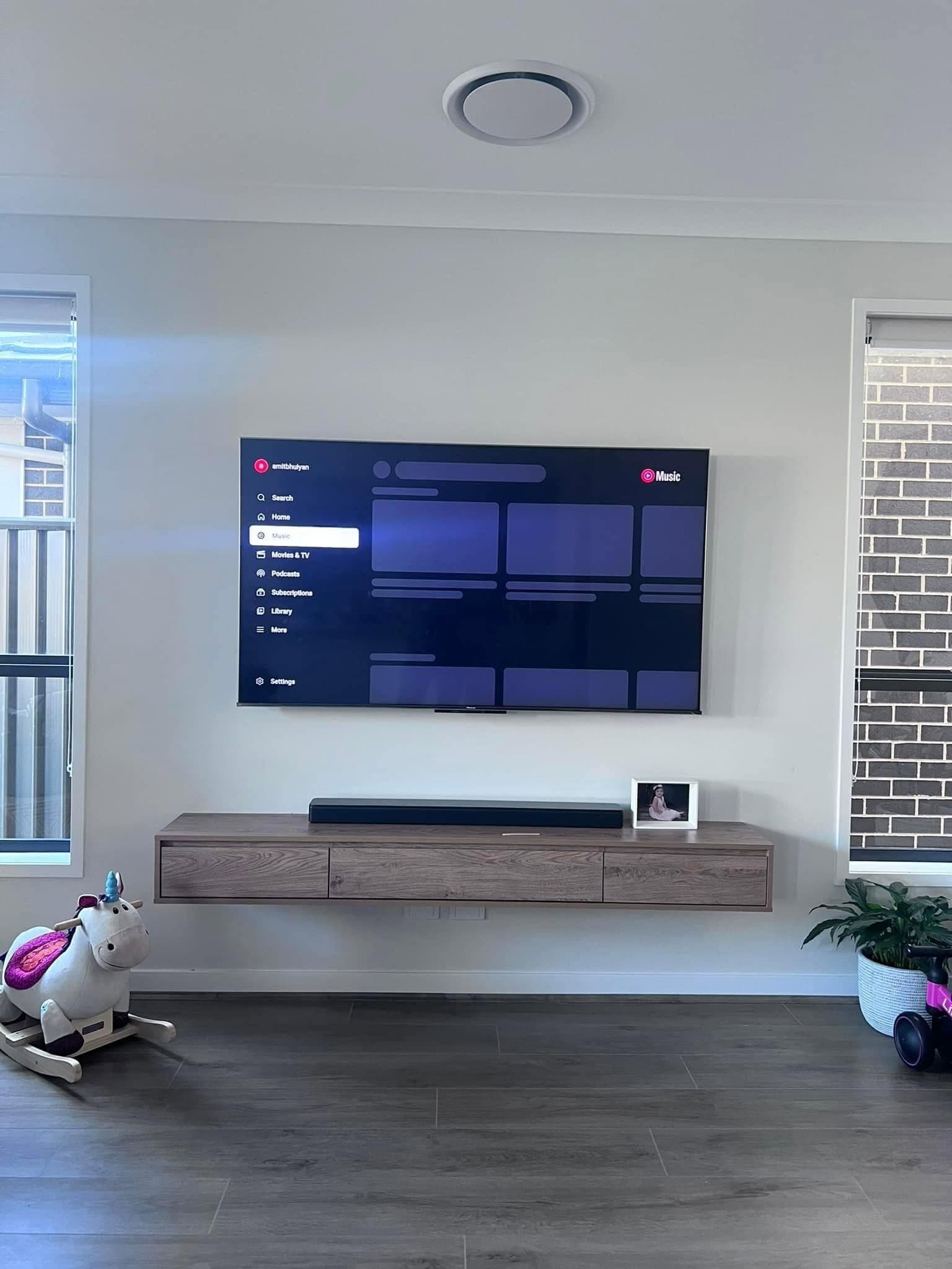 Wall-mounted TV over a floating timber unit