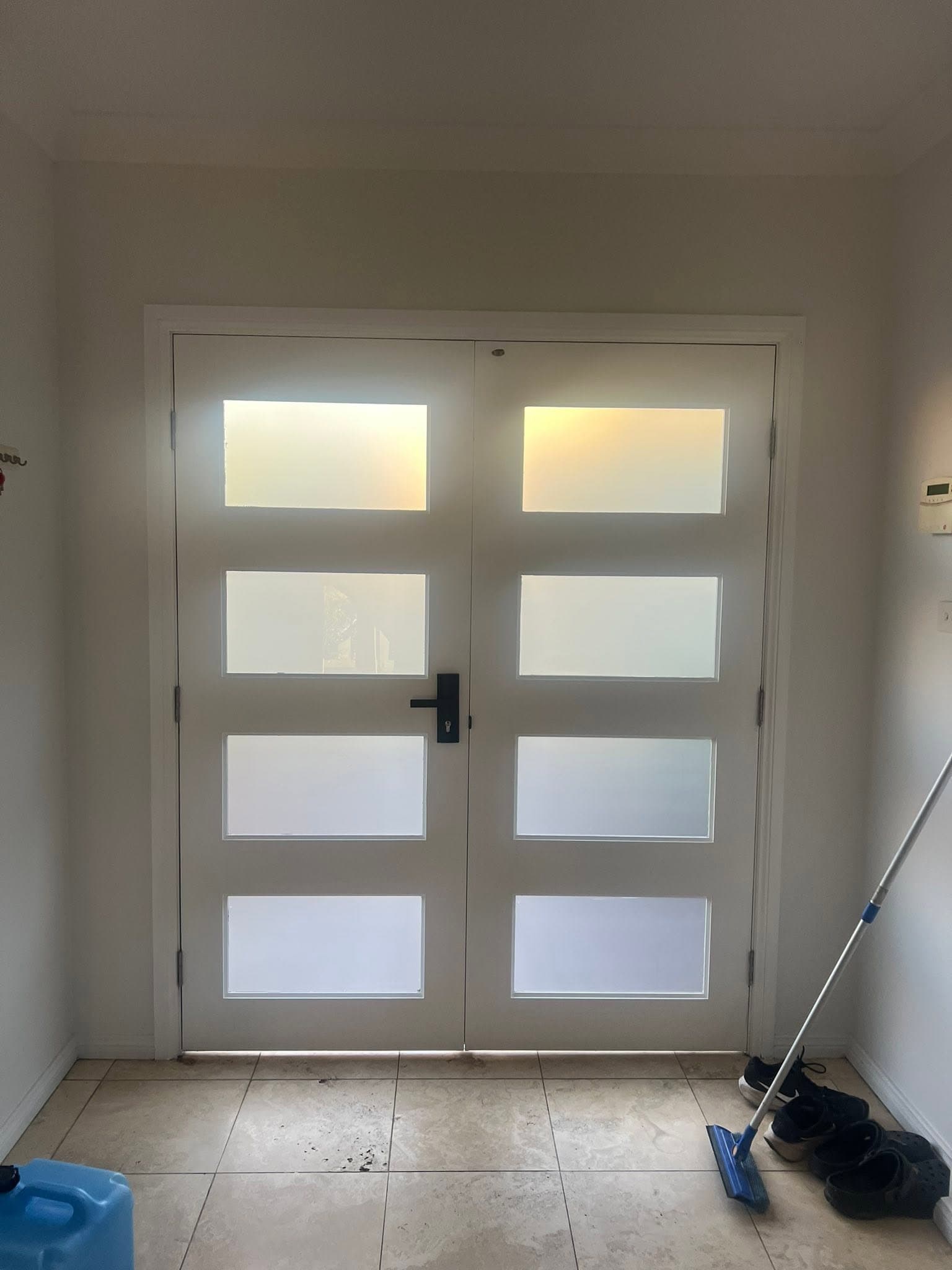 Frosted double entry doors seen from inside, installed