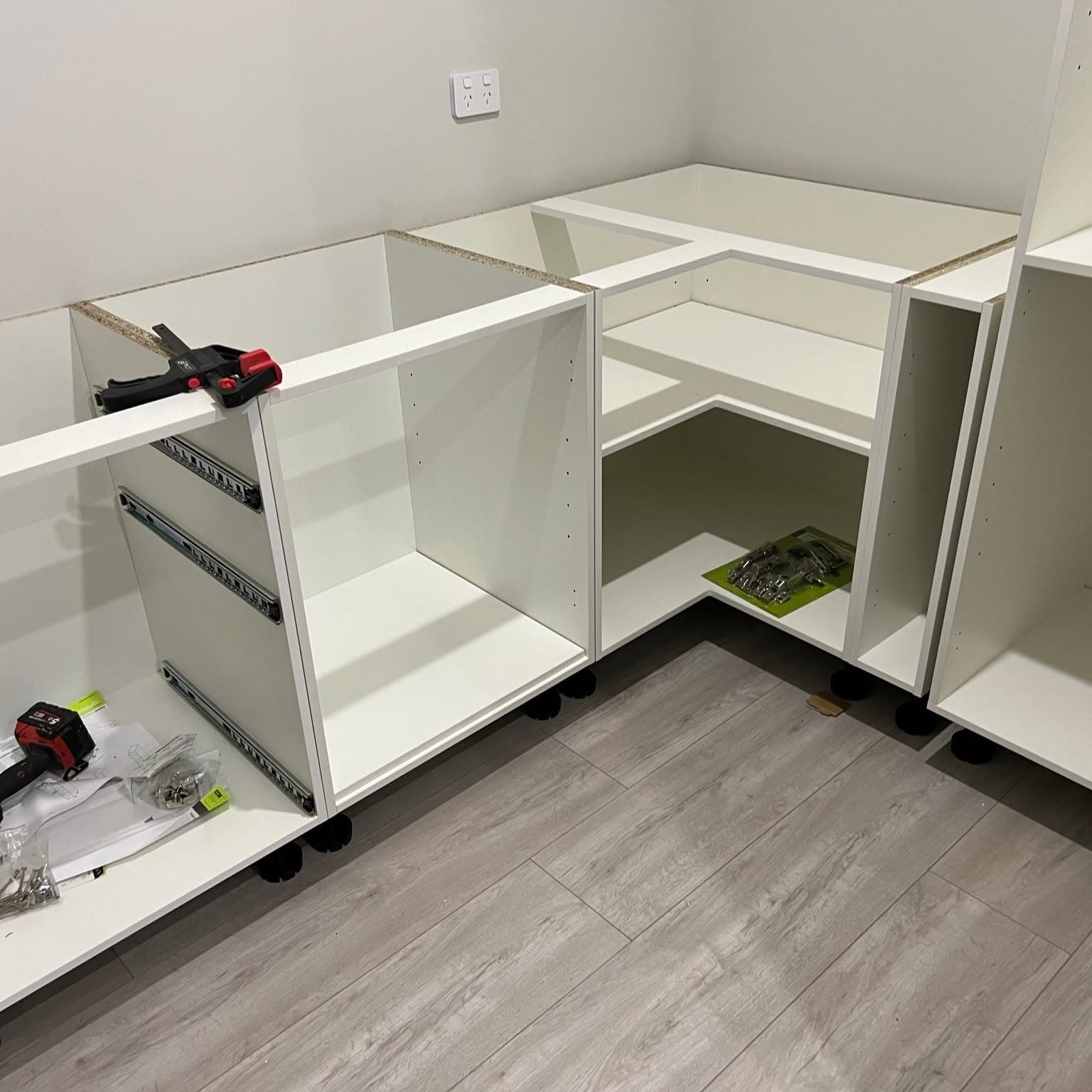Kitchen base cabinets levelled and clamped