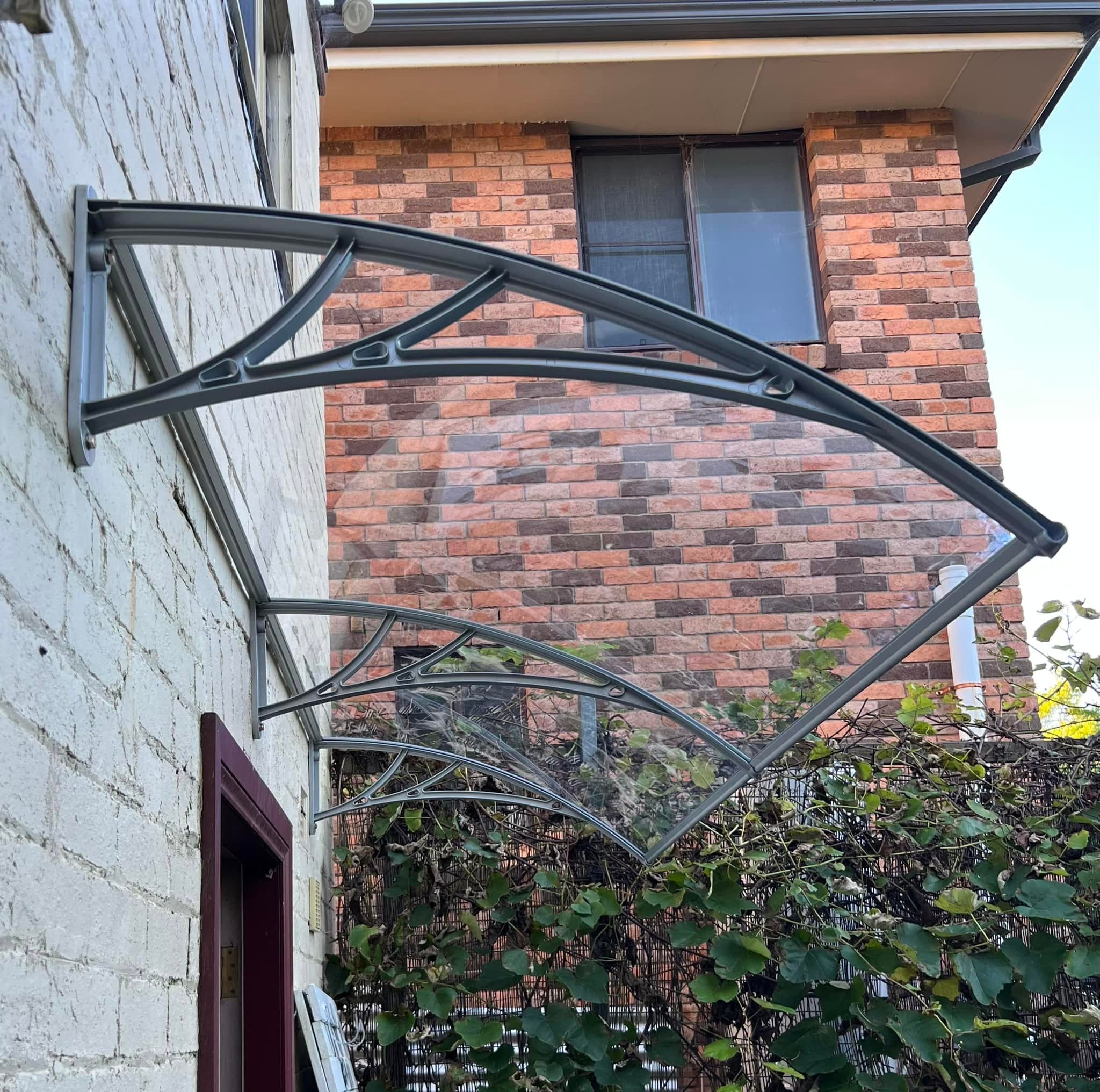 Polycarbonate door awning installed